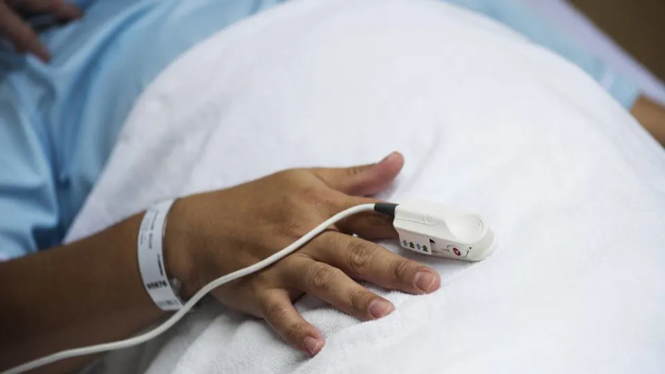 A saturation probe on a patient's finger